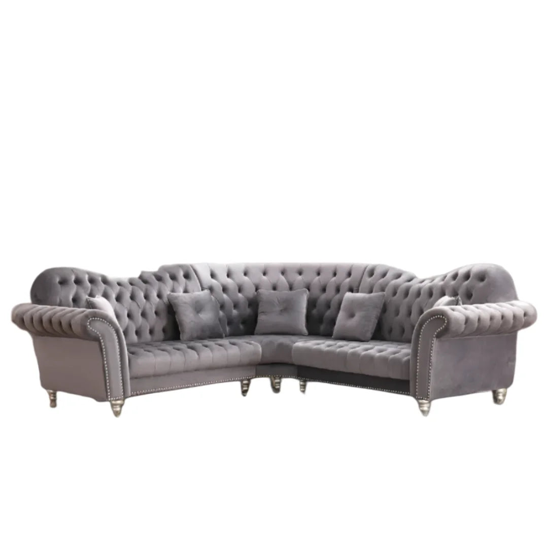 Gray tufted sectional sofa on a white background