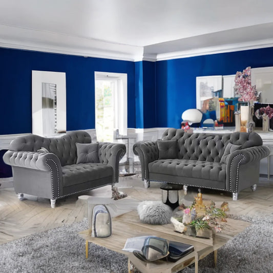 Living room with gray tufted sofas, a wooden coffee table, and decorative items.
