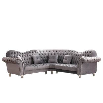 Gray tufted sectional sofa on a white background