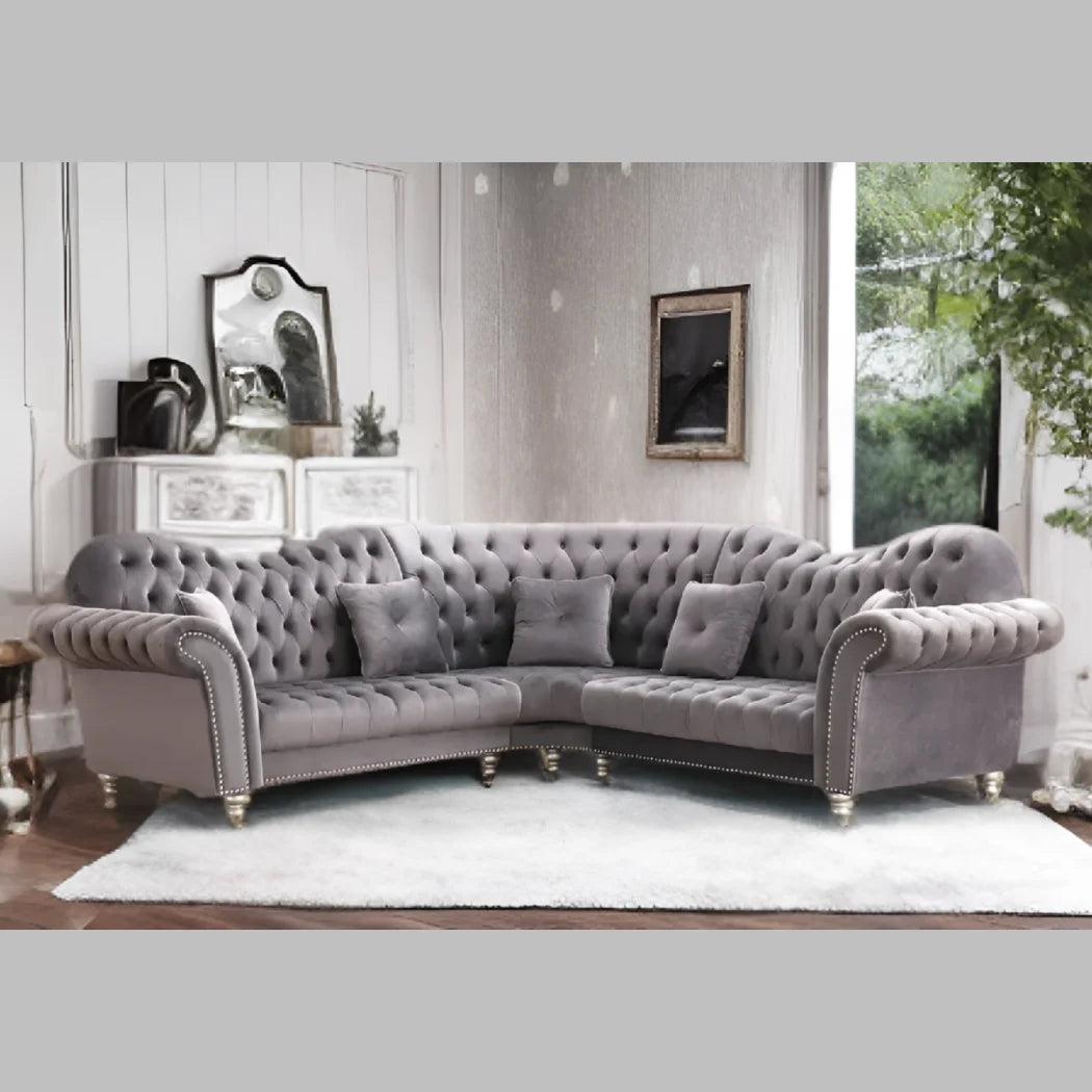 Elegance Gray tufted sectional sofa in a living room setting with decor elements.